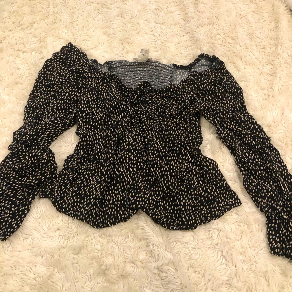 selling a black and white blouse for $13, originally $16 from URBAN romantics